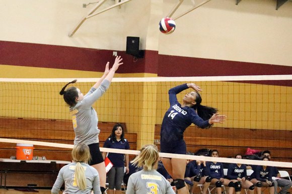 Kings Christian's Claire Bloomfield blocks a shot by Delano's Julie Ann Nicholas during Tuesday's quarter-final matchup with Delano. The Crusaders will play Sierra Pacific Thursday night at 6:30 in the semis.